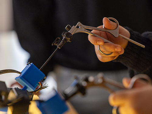 A surgeon using a tool during an operation.