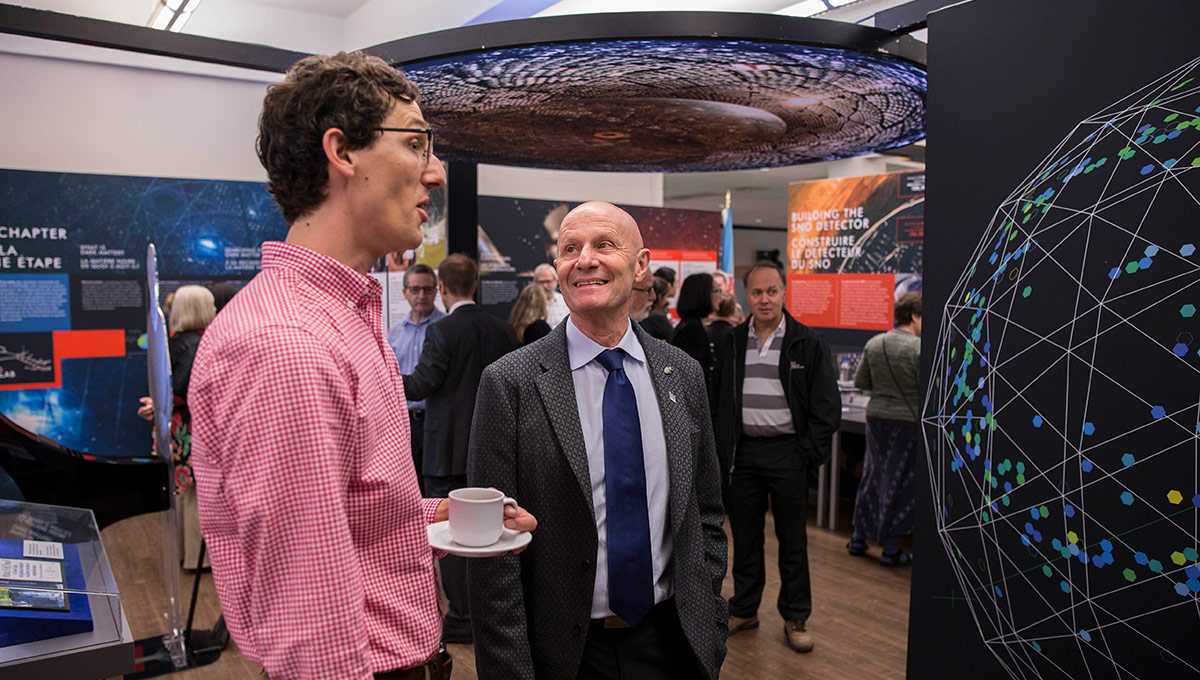 Two people discussing an exhibit.