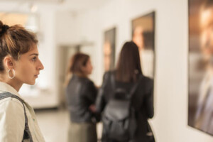 A group of women look at art in a gallery.