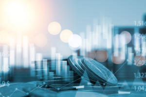 Blue double exposure of money coins stacking with bar graph for financial and investment business concept.