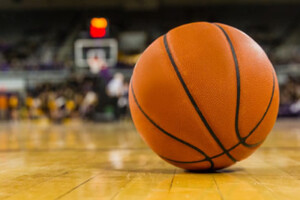 A basketball sits on a court.