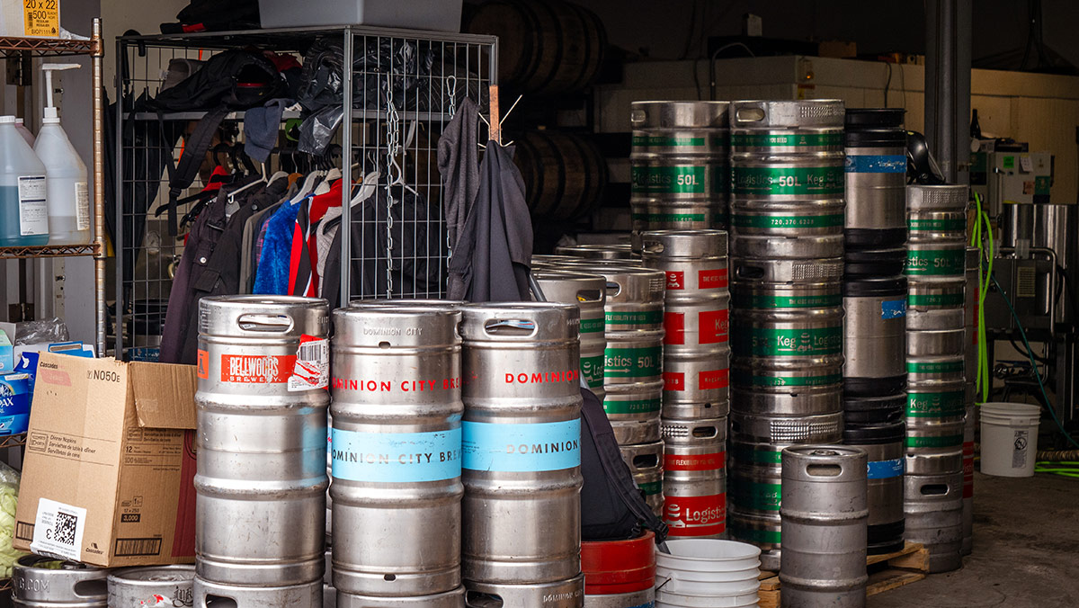 A stockpile of kegs in the warehouse of a brewing company.