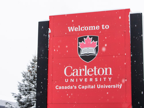 A snow-covered sign reading 