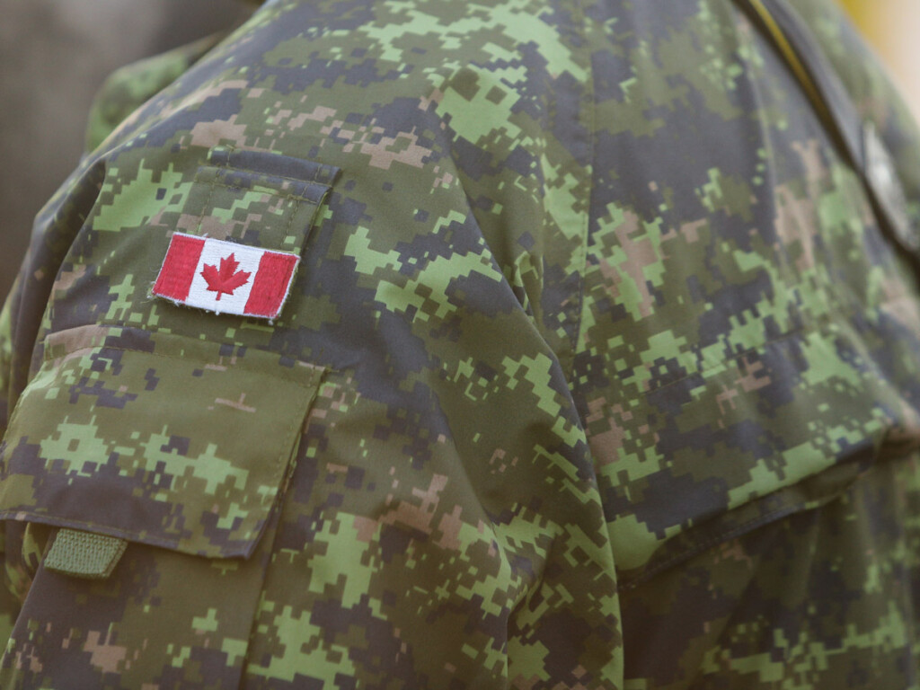 Details with the uniform and flag of Canadian soldiers taking part at the Romanian National Day military parade.
