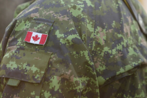 Details with the uniform and flag of Canadian soldiers taking part at the Romanian National Day military parade.
