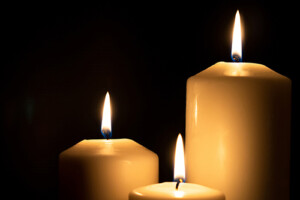 Candles burning on a black background