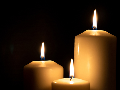 Candles burning on a black background