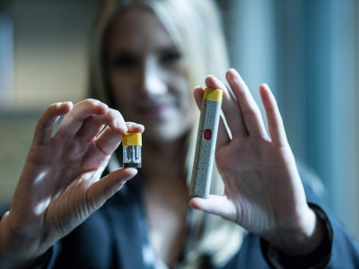 A Canopy Growth employee holds up two pieces of a devoce that could become the next generation of smart vaporizer technology.