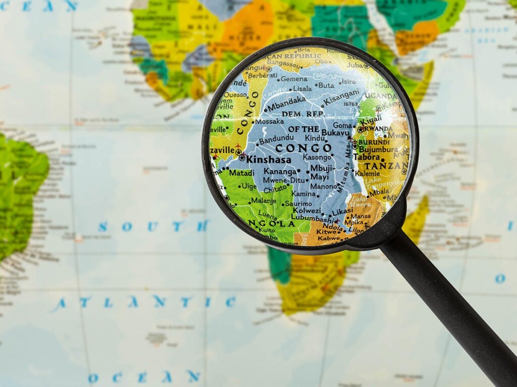 A magnifying glass hovers over Congo on a map of the world.