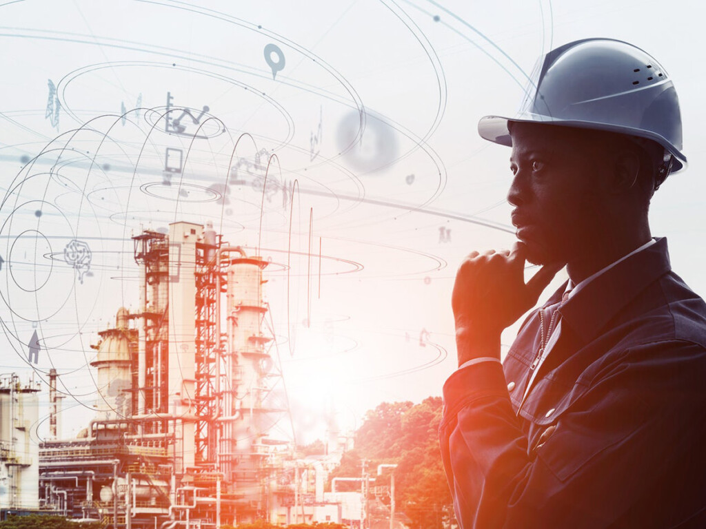 A composite image of a pondering architect with a hard hat and a high tech building, used to symbolize lacking AI empathy and ethical qualities