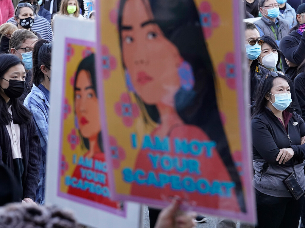 Protesters display placards during a rally held to support Stop Asian Hate, March 21, 2021, in Newton, Mass. (AP/Steven Senne)