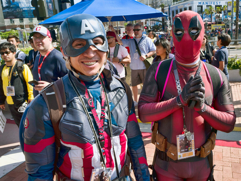 Fans pose as comic book characters Captain America and Deadpool