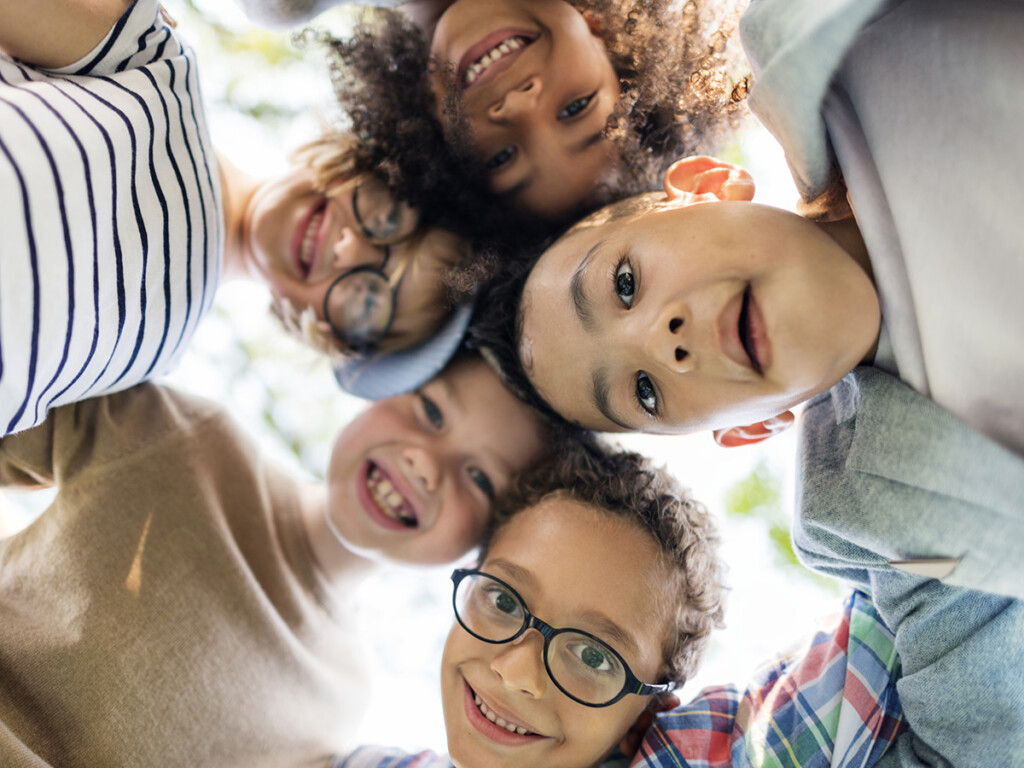 A group of children huddled together (Shutterstock)