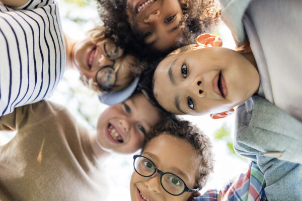 A group of children huddled together (Shutterstock)