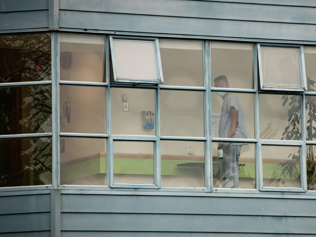 A worker is seen cleaning surfaces inside Little Mountain Place, a not-for-profit long-term care home in Vancouver where dozens of residents have died in the COVID-19 pandemic. (THE CANADIAN PRESS/Darryl Dyck)