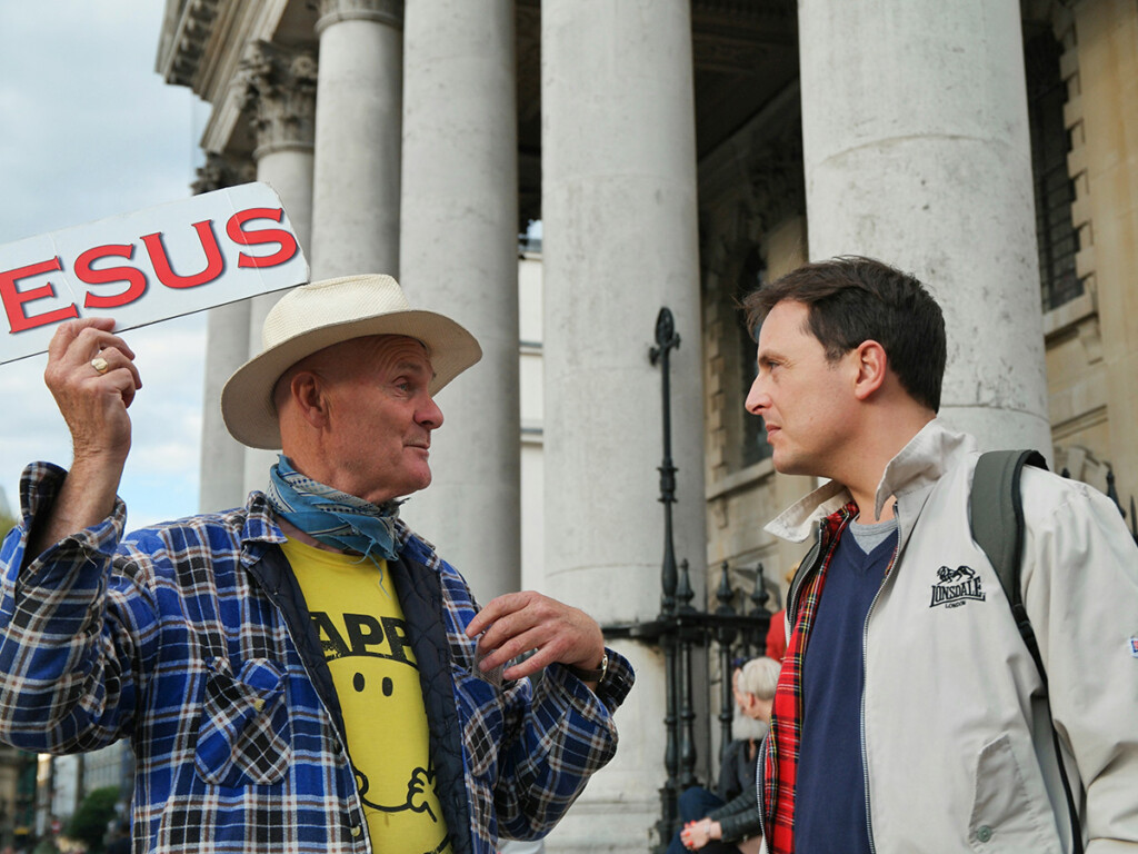 A man holds a Jesus sign at Trafalgar Square (Stop B), in London, United Kingdom. (Malcolm Lightbody/Unsplash, CC BY)