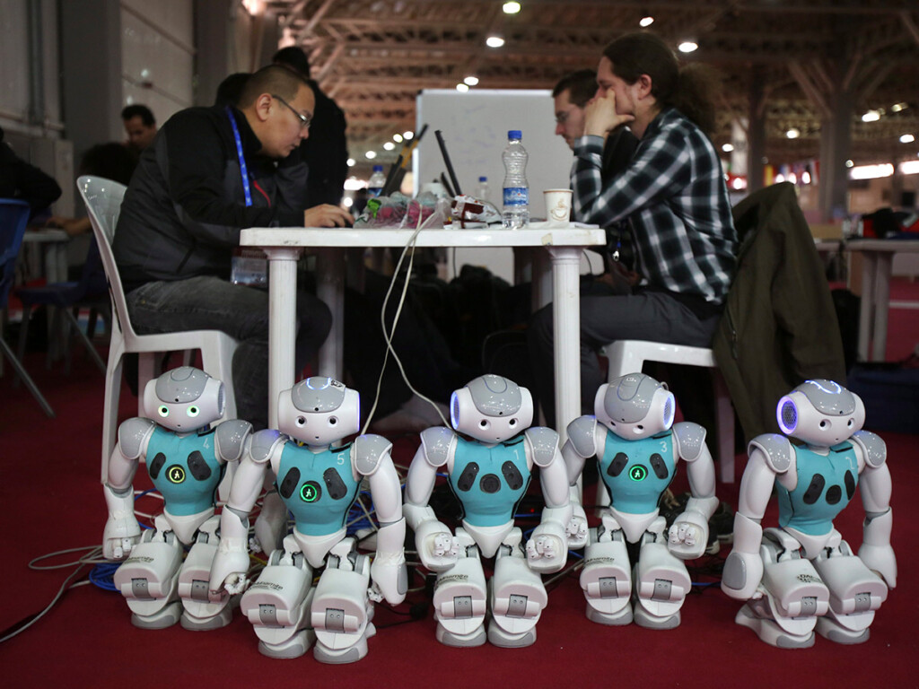 Humanoid robots at an international robotics competition in Tehran, Iran, during 2014. Students from 22 countries, including Canada, were competing during the three-day event. (AP Photo/Vahid)