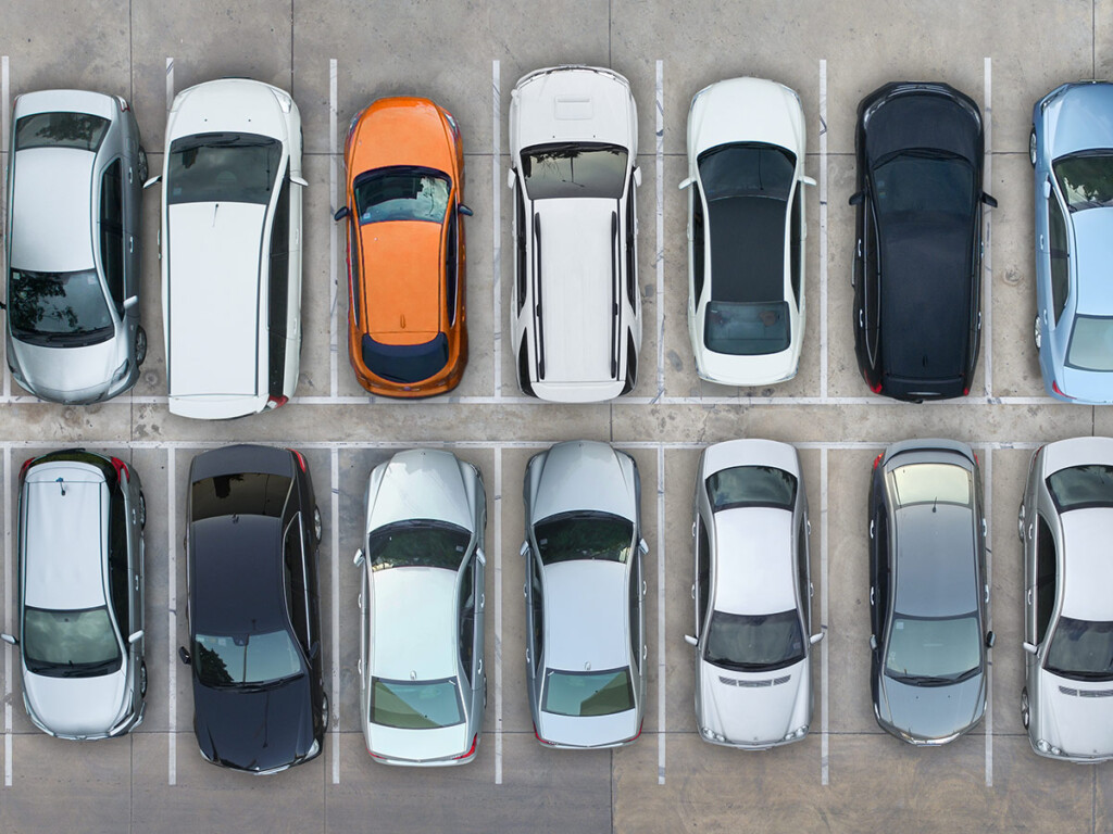 Two parallel rows of self-driving cars that are parked.