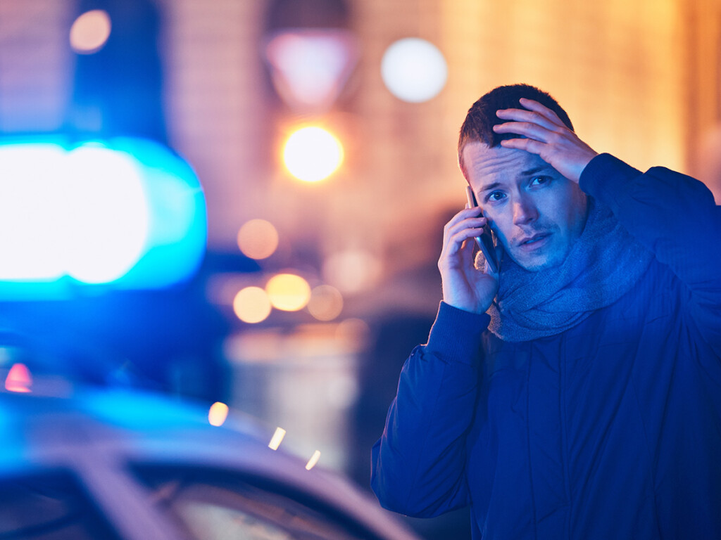 A distressed man on a mobile phone.