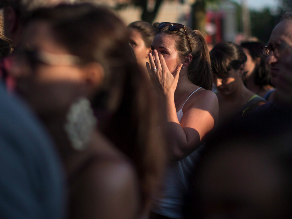 A woman wipes a tear as a Greektown neighbourhood community gathers for a candlelit vigil (THE CANADIAN PRESS/Chris Young)