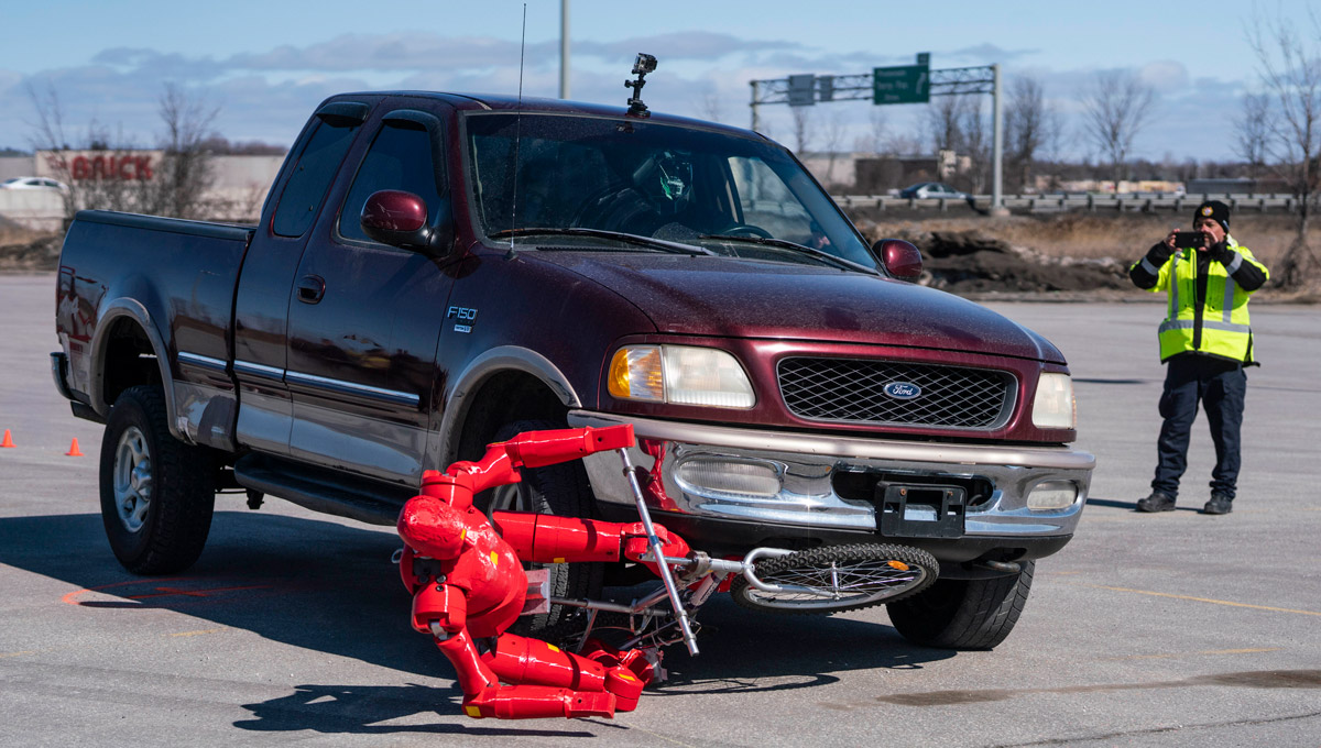 A truck collides with the crash test dummy.