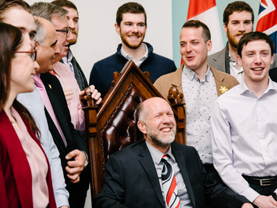 The men's curling team gathers with Mayor Jim Watson and Councillor Mathieu Fleury at City Hall.