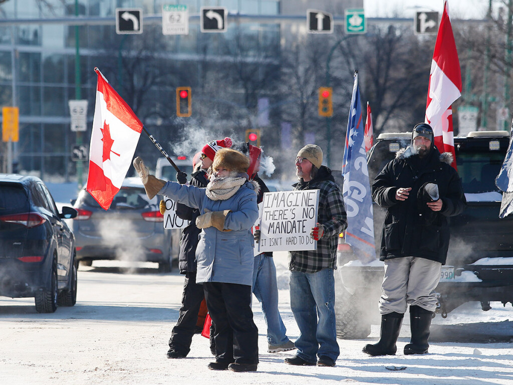 A small group of COVID-19 mandate protesters remain on the street as the group packs up and prepares to head home on Memorial Blvd in Winnipeg, Man. on Feb. 23, 2022. (THE CANADIAN PRESS/John Woods)