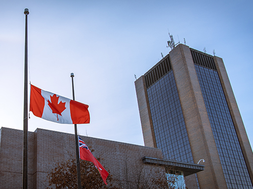 Flag at half mast with Dunton Tower visible in the background