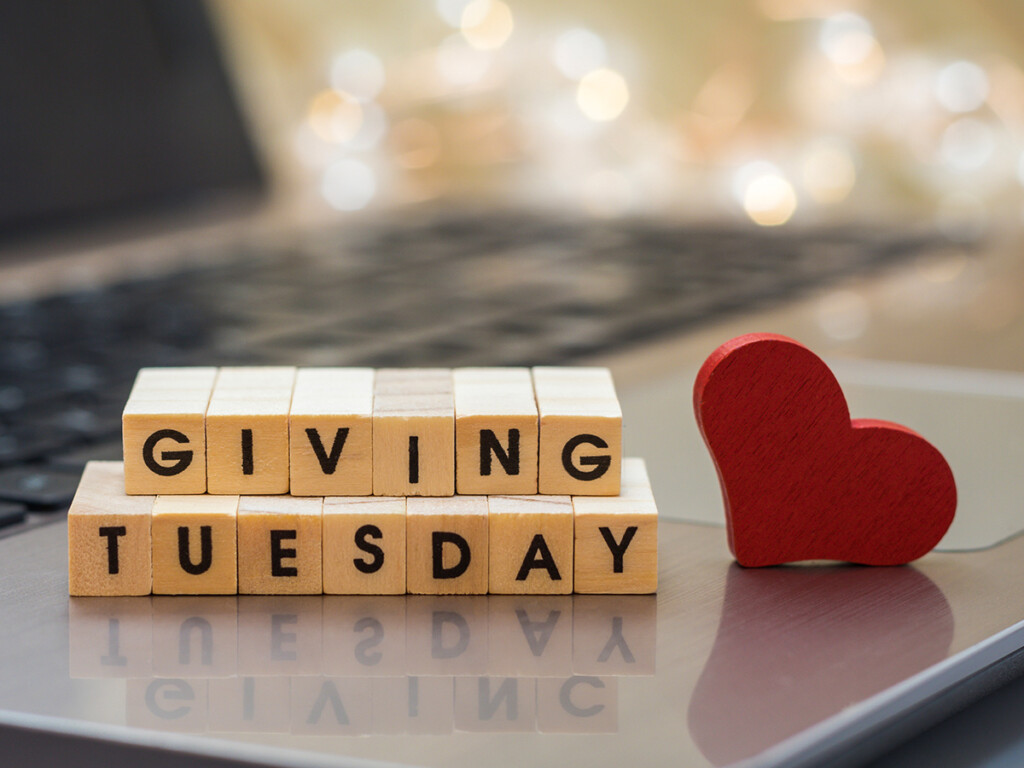 Giving Tuesday block letters sitting on a laptop