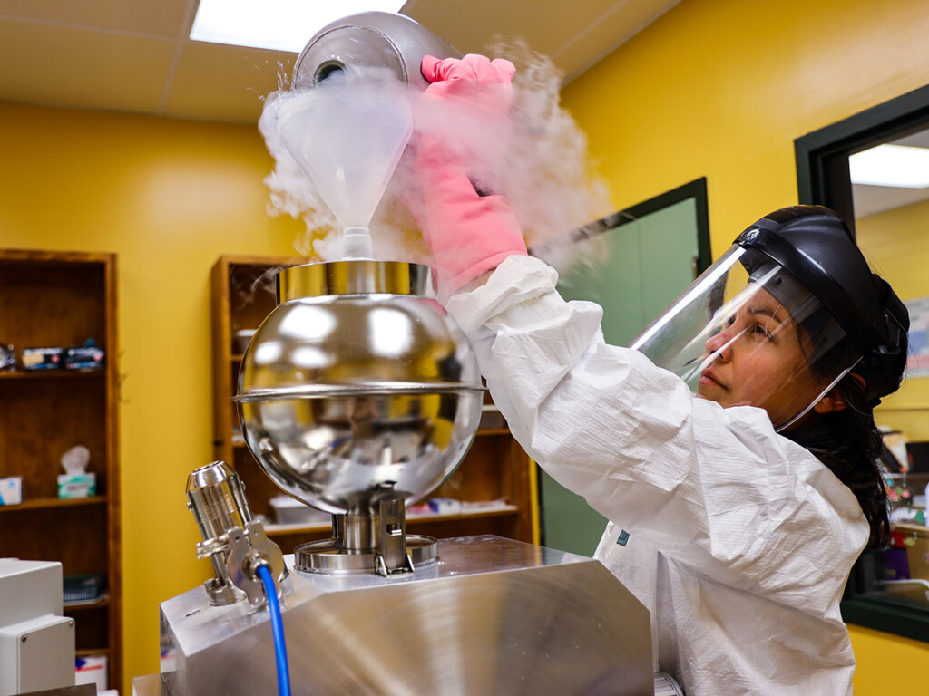 A scientist conducting an experiment using unidentified machinery to uncover the secrets of the origins of life.
