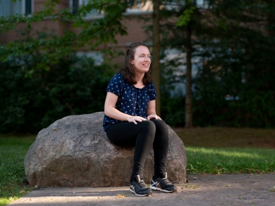 Hannah MacLellan sits outside in Carleton's Residence Quad. Hannah has accomplished a lot at the age of 19 and she’s just getting started in her life-long quest for disability rights.