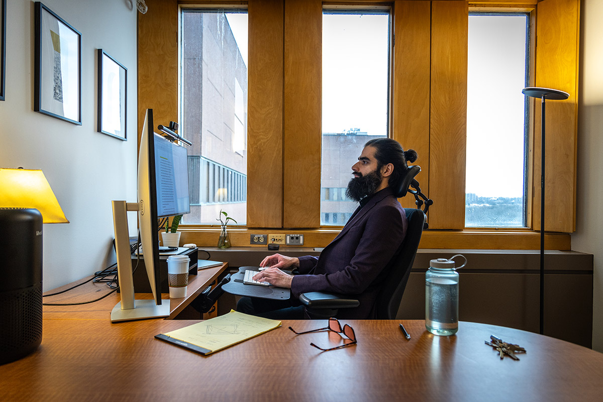 A man working on a computer in an office.
