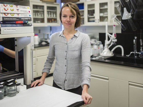 Hillary Maddin in her lab surrounded by equipment.