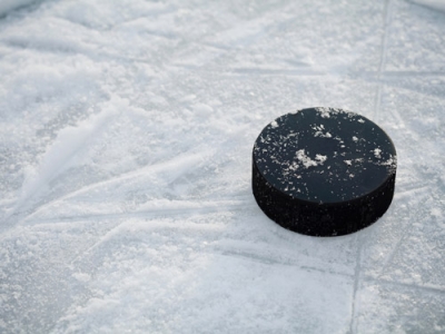 An image of a hockey puck on the ice.