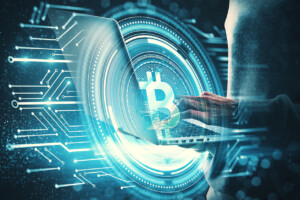 Hacker using laptop with bitcoin circuit on blurry blue background