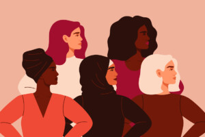 Five women of different nationalities and cultures standing together.