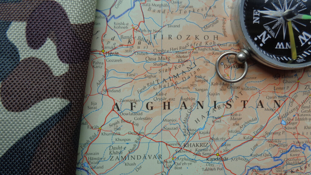 A map of Afghanistan with a compass and camouflage material depicting the Afghan War