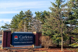 The Bronson Avenue Carleton University sign with trees in the background