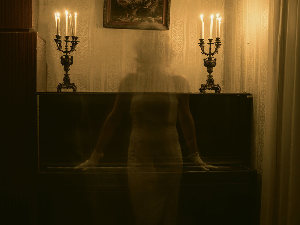 Spirits channelled by a music composer, floating over an old piano.