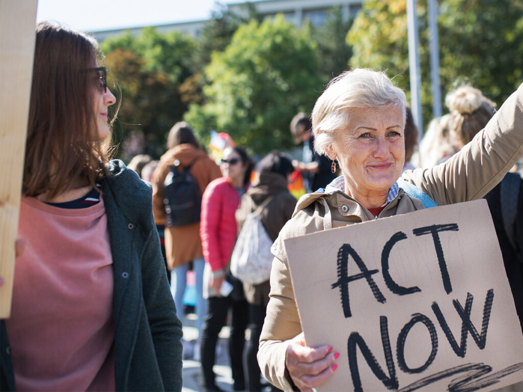 A sign that says 'Act Now' Equal rights protest