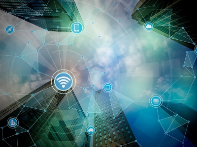 An artistic image of the concept of connectivity. Tall buildings are seen to be connected by a web of radio signals.