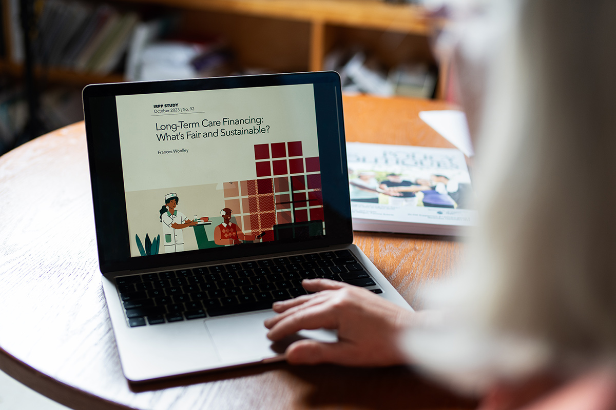 An over the shoulder view of someone using a laptop.