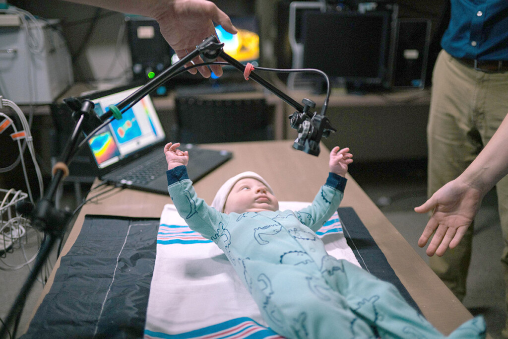 A baby laying on a blanket.