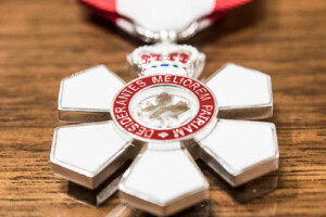 The Order of Canada insignia displayed on a wooden surface
