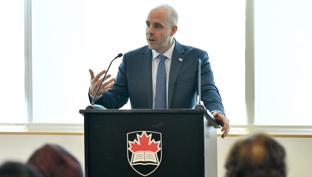 Carleton President Benoit-Antoine Bacon speaks at a podium during the annual Orientation for Newly Arrived Diplomats in September 2018.