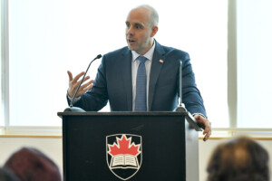 Carleton President Benoit-Antoine Bacon speaks at a podium during the annual Orientation for Newly Arrived Diplomats in September 2018.