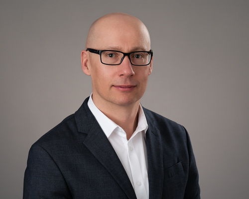 A professional headshot of Peter Drogosiewicz