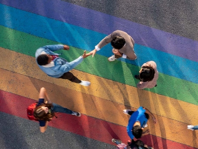 Students walking on the rainbow road located on the Carleton campus