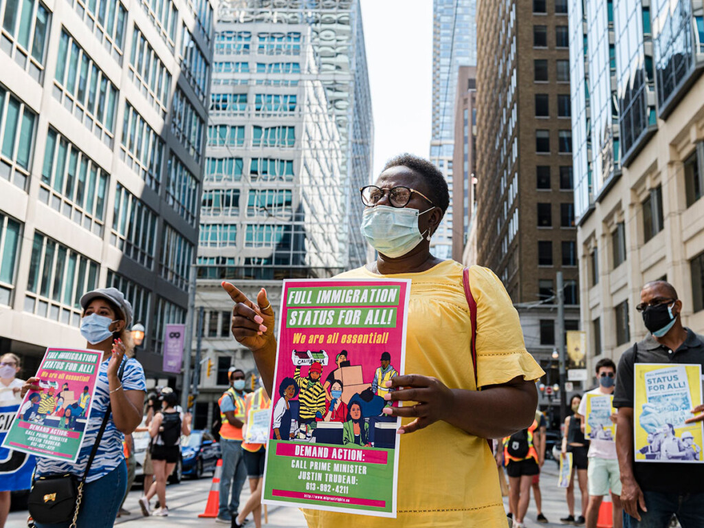 Protestors support migrant worker rights in front of the Immigration and Refugee Board of Canada building in Toronto