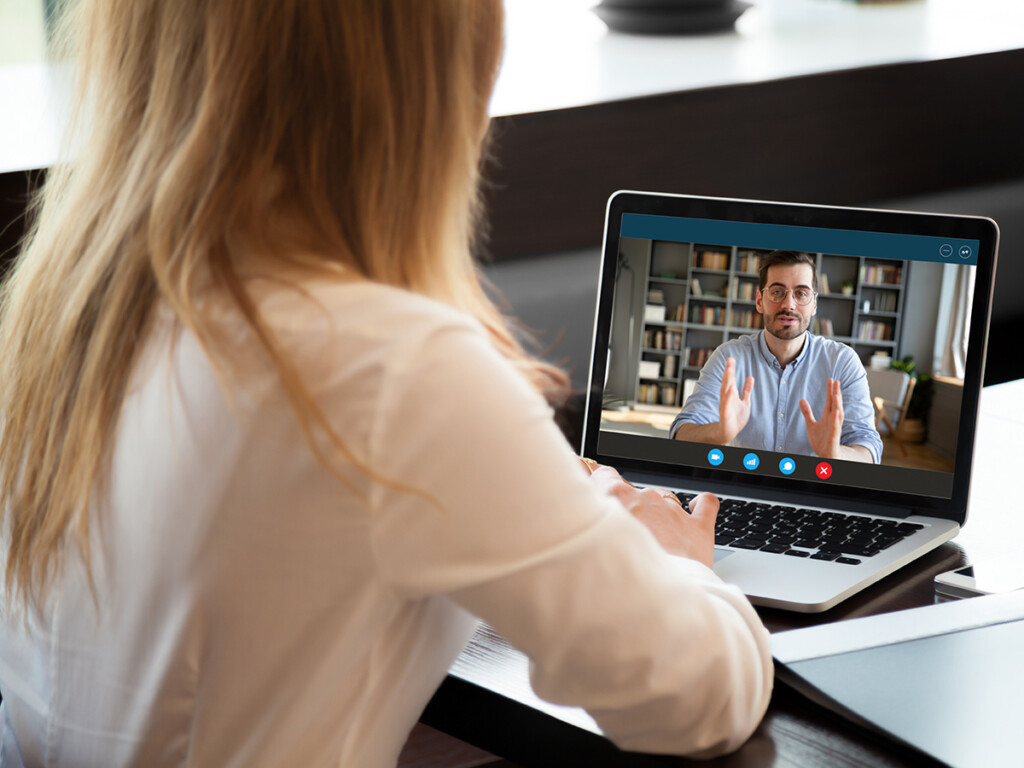 View over shoulder of a student engaging in a video call. (Photo: iStockPhoto)